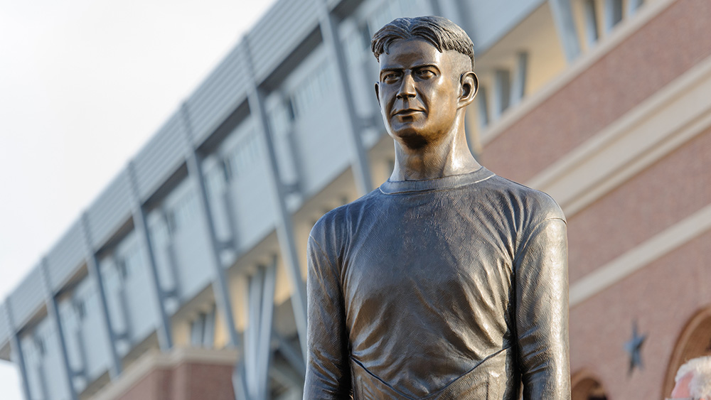 A statue representing 12th man stands proud in front of Kyle Field.