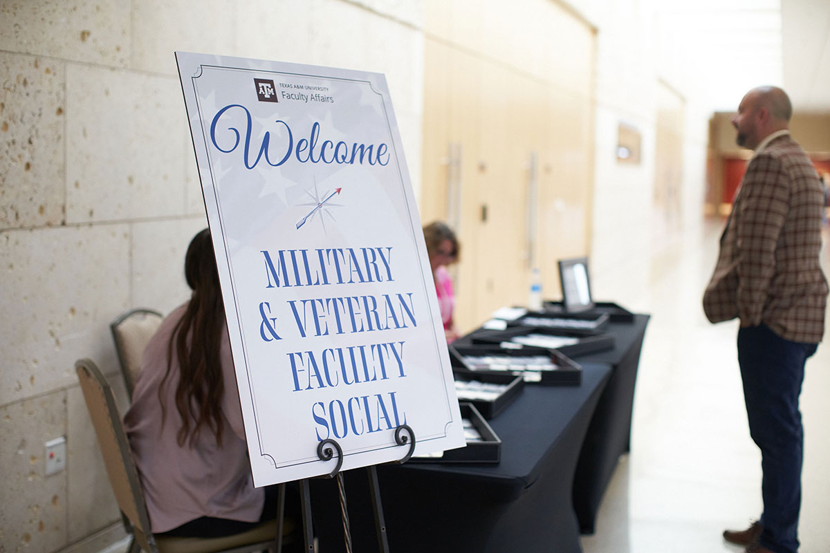 A poster board reads, welcome military and veteran faculty social.