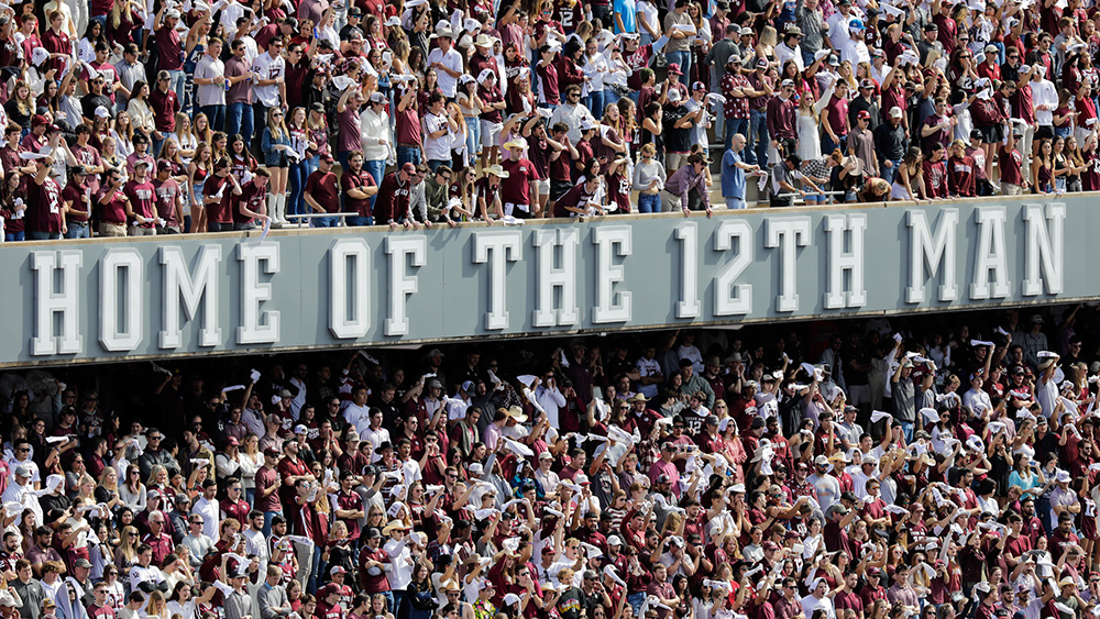 Home of the 12th man sign at a packed Kyle Field football stadium